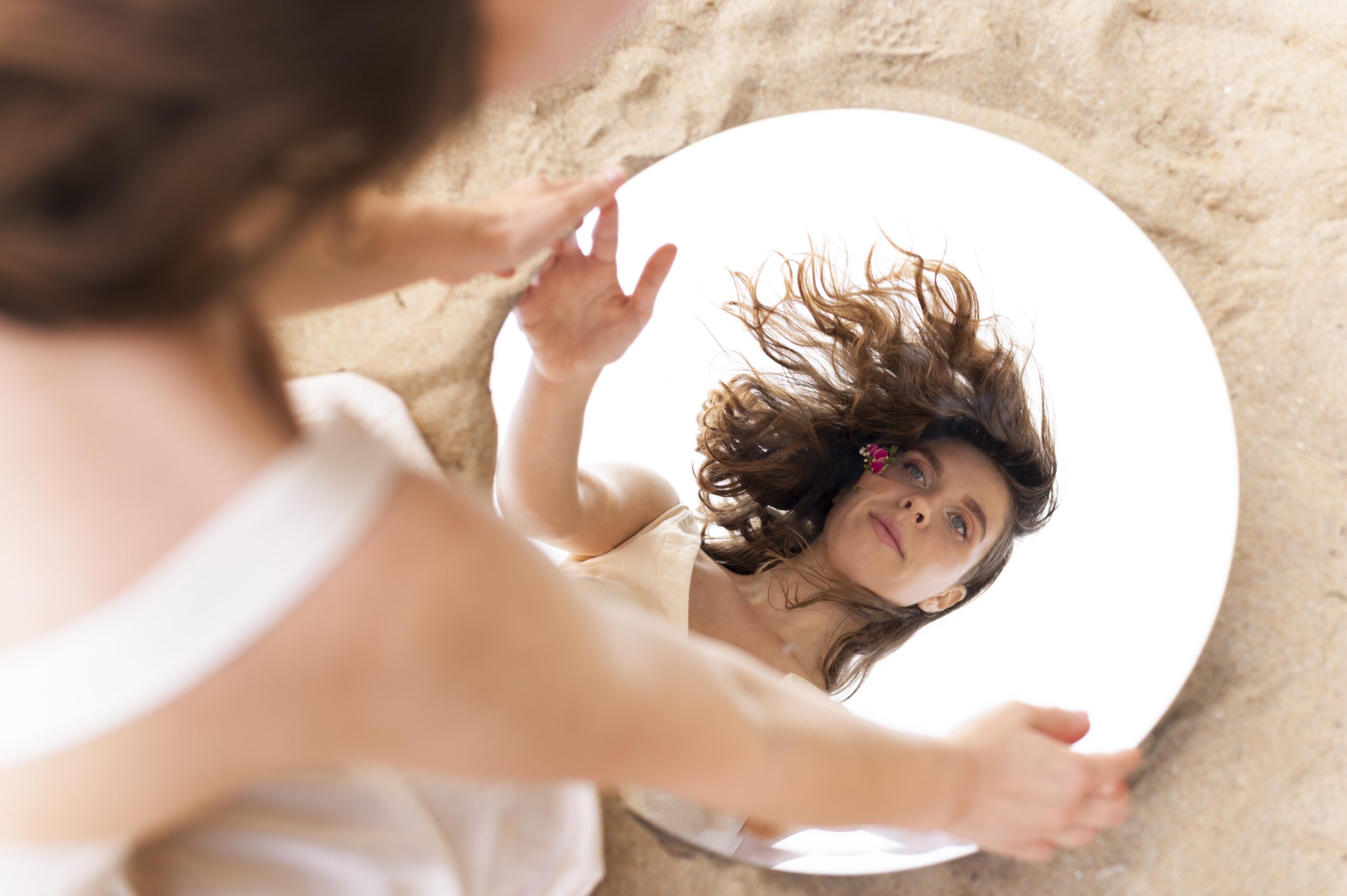 portrait-young-woman-posing-confidently-outdoors-with-round-mirror