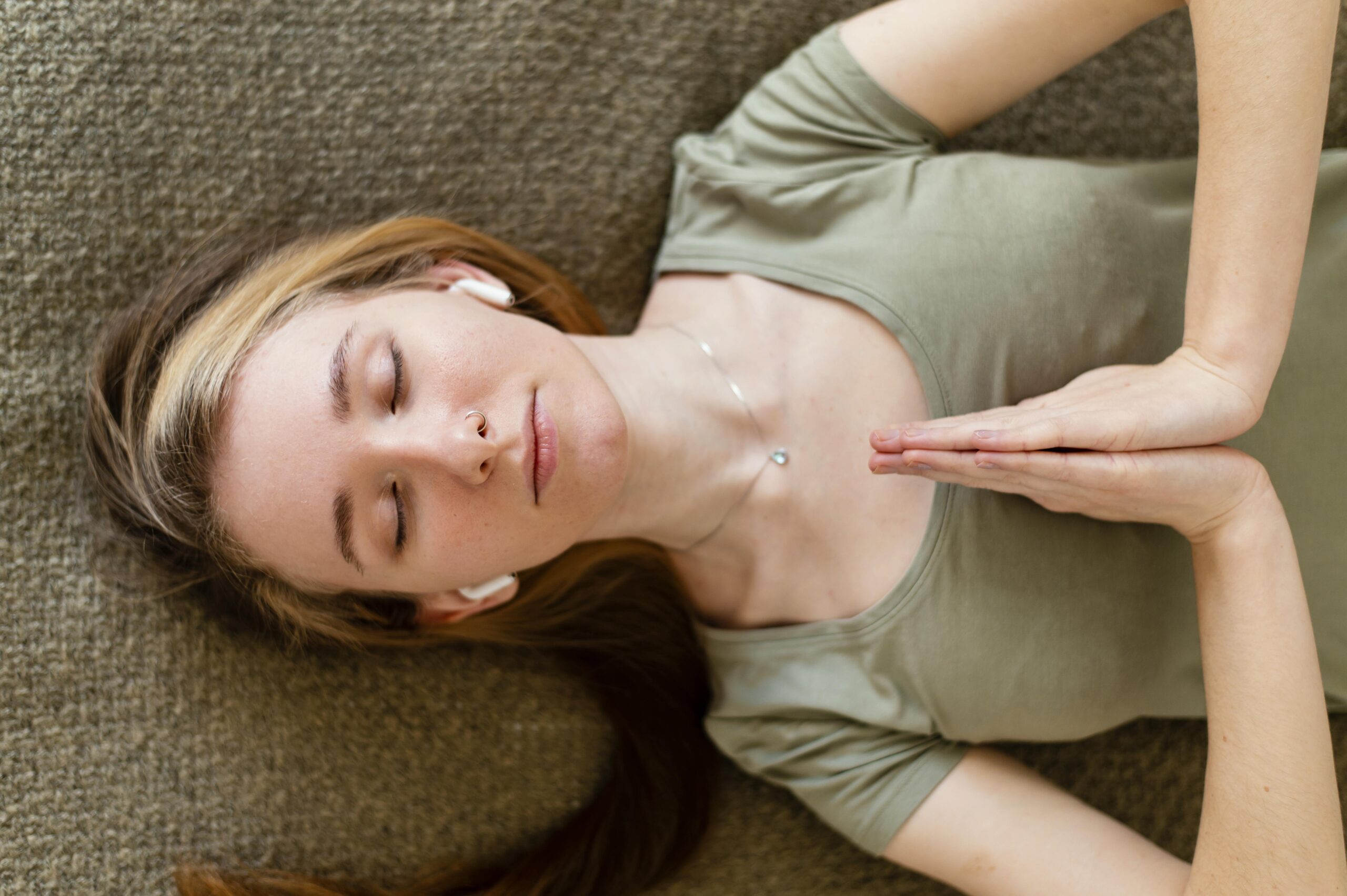 young-woman-meditating-home-laid-floor